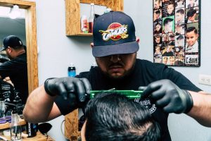 A man getting his groomed at a barber shop - Darren Yaw Foo Hoe