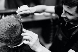 A man getting his haircut at a barber shop - Darren Yaw Cambodia